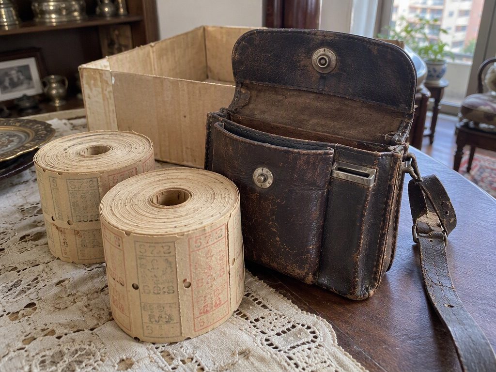 Two uncut rolls of tram tickets and a conductor’s pouch