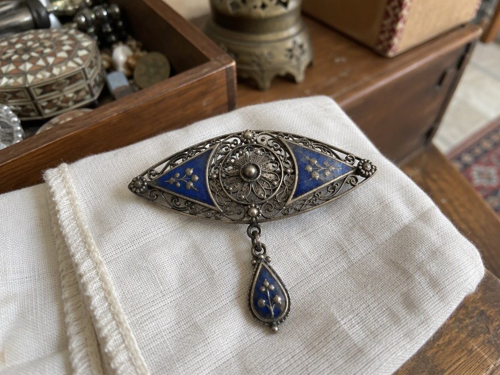 Silver filigree brooch with blue enamel and a matched drop